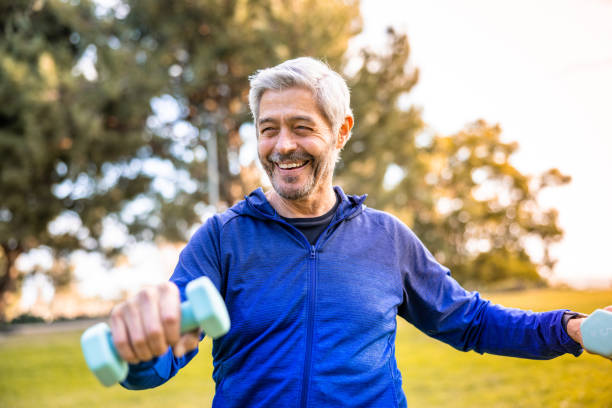 istock Senior man working out outside with weights 1446349822