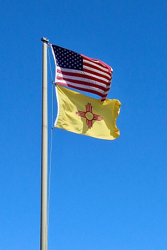 Flags of the United States and New Mexico with its Sun Zia