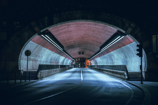 A dark tunnel where cars drive