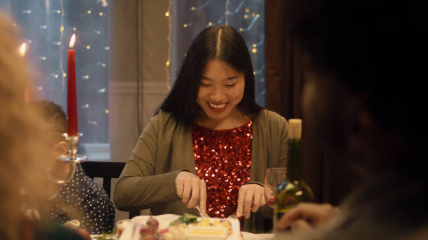 istock Asian woman eats on Christmas family dinner 1446354611