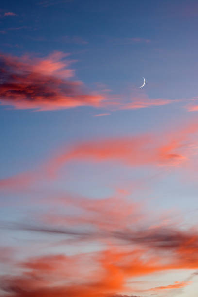 istock New moon and red clouds at sunset 1446355789