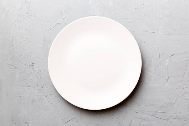 istock Top view of empty light plate on cement background. Empty space for your design 1446360197