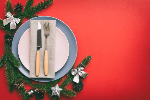 istock Christmas table place setting with christmas decor and plates, kine, fork and spoon. Christmas holiday background. Top view with copy space 1446360294