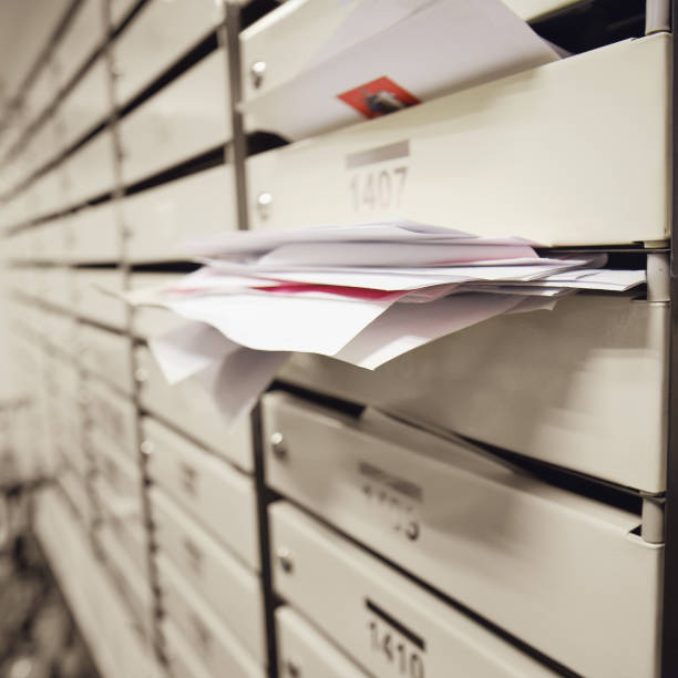 istock Mailboxes filled with letters and bills in an apartment building. An overflowing postbox in the hallway of the house 1446361531