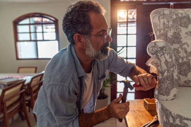 istock An elderly man reupholsters his armchair at home 1446365592
