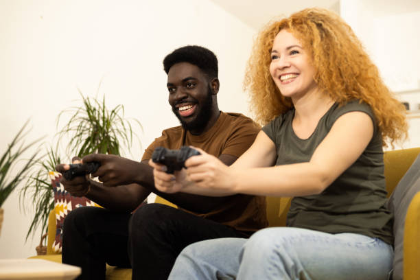 istock Young couple having fun playing video games 1446371178