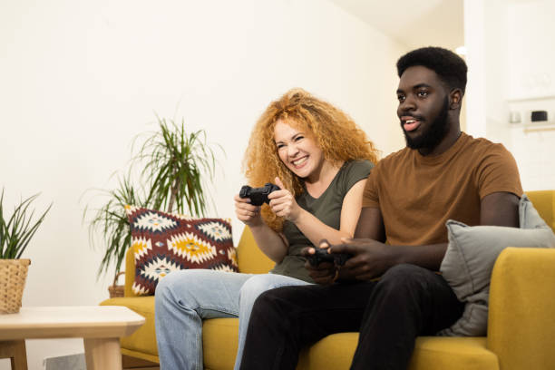 istock Young couple having fun playing video games 1446371217