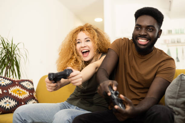 istock Young couple having fun playing video games 1446371232