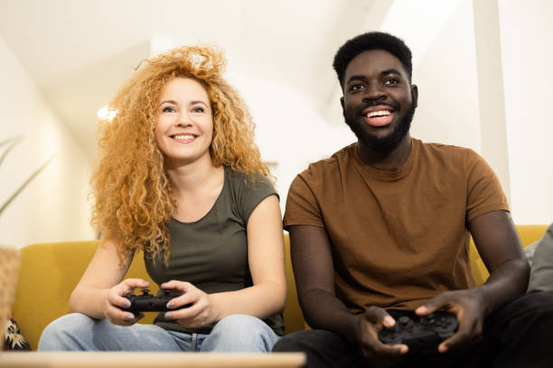 istock Young couple having fun playing video games 1446371239