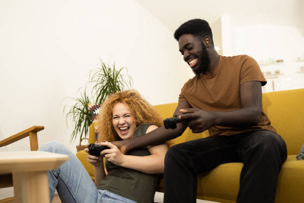 istock Young couple having fun playing video games 1446371270