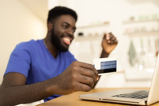 Young man shopping online from home