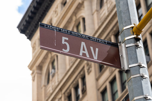 Close up of 5 AV street sign is seen in New York City, USA. 5 AV (Fifth Avenue) is a major thoroughfare in the borough of Manhattan.