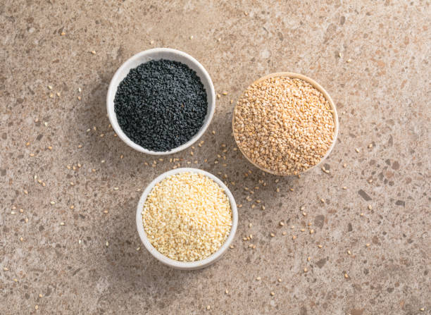 istock Set with different sesame seeds on stone background. top view. 1446373912