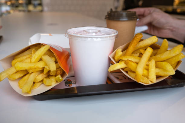 Fast food on a tray in a restaurant. French fries, a glass with a milkshake, coffee Fast food on a tray in a restaurant. French fries, a glass with a milkshake, coffee Mcdonalds Chips stock pictures, royalty-free photos & images