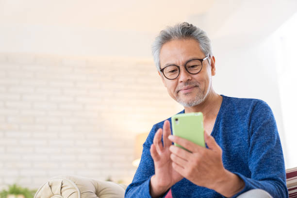 istock elderly man who uses smart phone, 1446377681