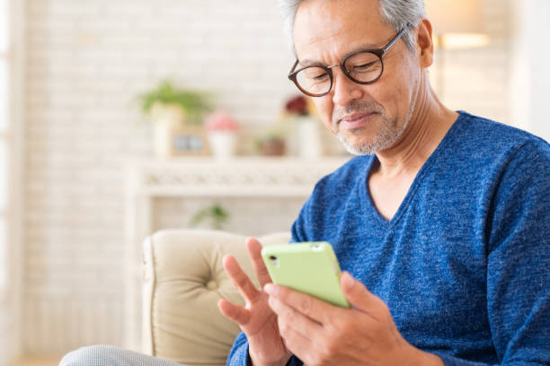 istock elderly man who uses smart phone, 1446377774