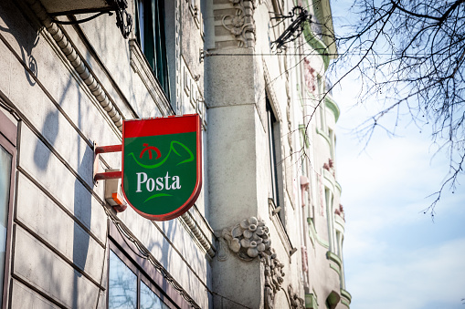 Picture of a sign with the logo of Magyar Posta on one of their post offices in Budapest, Hungary. Magyar Posta Zrt. or Hungarian Post is the postal administration of Hungary. Besides normal mail delivery, Magyar Posta also offers logistics, banking, and marketing services.