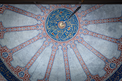 Picture of the detail of an ancient arabic calligraphy written in ottoman alphabet in the ayasofya saint sofia mosque in istanbul, Turkey.