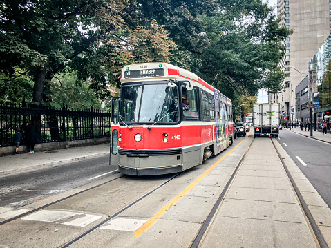 An old style streetcar running on the track.