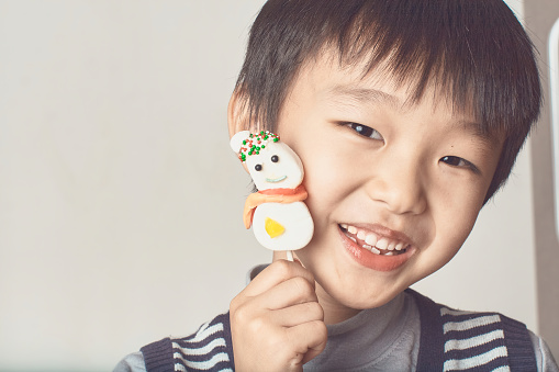 Asia  boy hand holding xmas candies stick