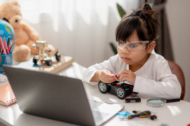 istock Asia students learn at home in coding robot cars and electronic board cables in STEM, STEAM, mathematics engineering science technology computer code in robotics for kids concept. 1446388862