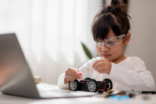 istock Asia students learn at home in coding robot cars and electronic board cables in STEM, STEAM, mathematics engineering science technology computer code in robotics for kids concept. 1446388865