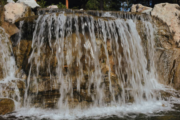 istock water fall falling into a pond below creating a lot of water spray, bubbles and splashes 1446388927