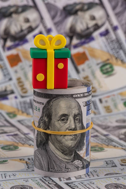 istock Symbolic Christmas present and 100 US dollar bills 1446391685