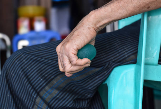 istock Asian elder man gripping hand exercise elastic ball. 1446398450