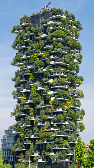 Milano, Italy. Bosco Verticale. Amazing view at the modern and ecological skyscraper with many trees on each balcony. Modern architecture, vertical gardens, terraces with plants