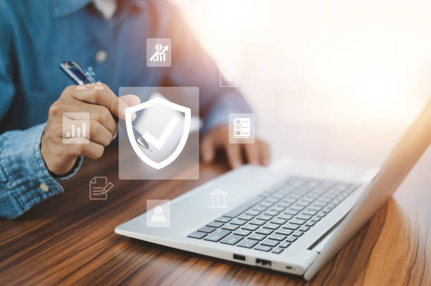 istock Man using  computer buy insurance online at home 1446401306
