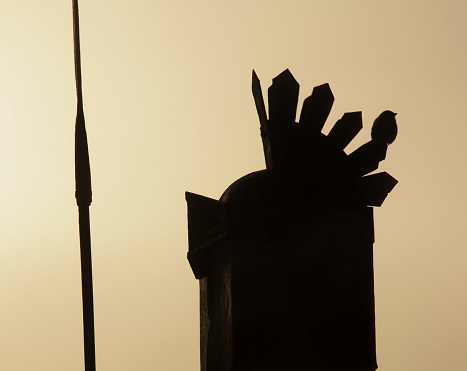 Lugo city, Spain- March 19, 2011: Statue of  roman soldier silhouetted at dusk,  close-up, gold colored sky background, outline, Lugo city, Galicia, Spain.