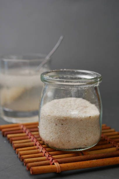 istock Wooden Spoon with Psyllium Seeds on dark background 1446402361