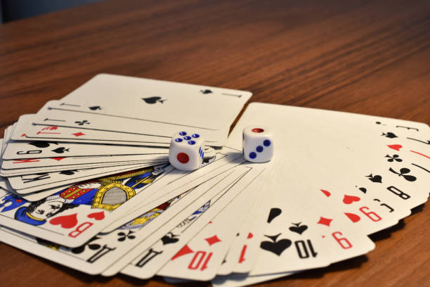 istock Fanned cards and dice on the table. 1446405273