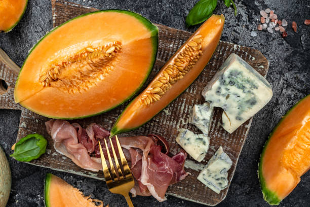 istock appetizer with sweet melon and ham, dorblu stilton dairy product, blue cheese roquefort gorgonzola, roquefort, cambozola, Food recipe background 1446405410