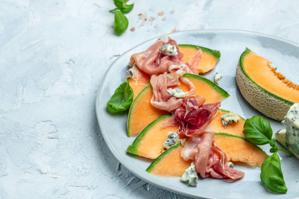istock appetizer with sweet melon and ham, dorblu stilton dairy product, blue cheese roquefort gorgonzola, roquefort, cambozola, Food recipe background 1446405453