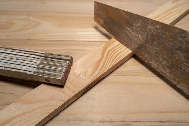 istock Folding ruler, hand saw and a wooden board on the workbench 1446405604