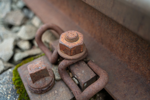 Close up of a old rusted iron bolt from a railroad track