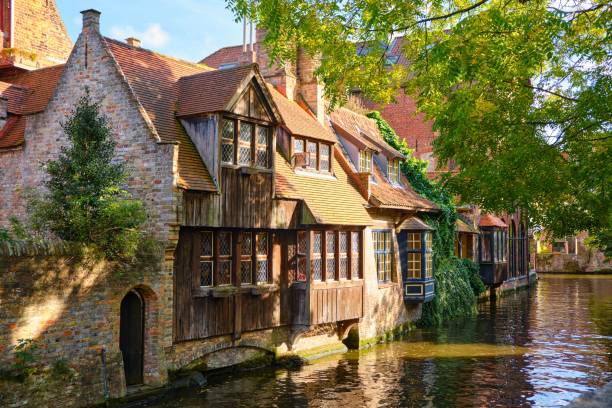 istock Old buildings in front of a river on a sunny day surrounded by trees 1446406353