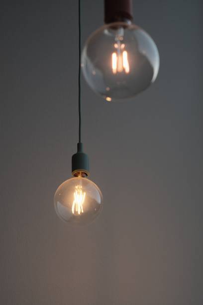 istock Vertical selective focus of pendant lamps on a gray background 1446406365