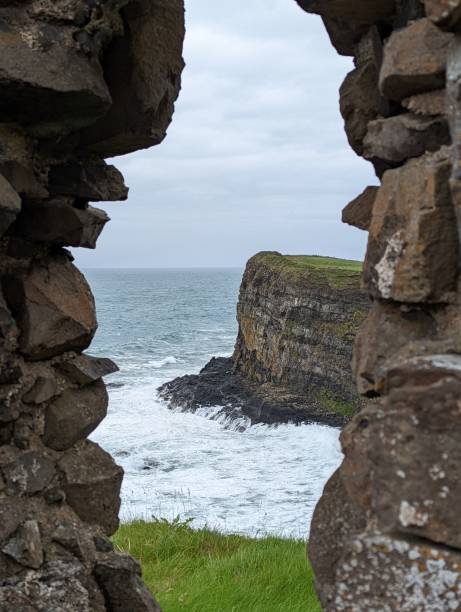 istock Beautiful view of wavy sea with cliffs under the cloudy sky 1446406727