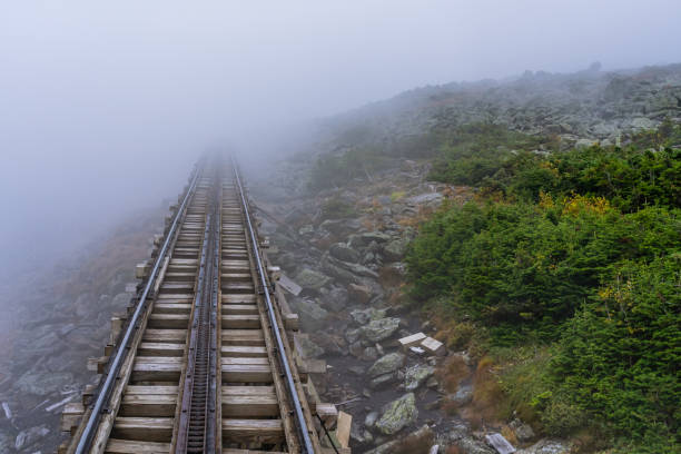 an old railroad leading to the misty peak of mount washington. the world's first rack railway. - rack railway imagens e fotografias de stock