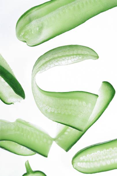 istock Closeup of cutted cucumbers isolated in white background 1446409877