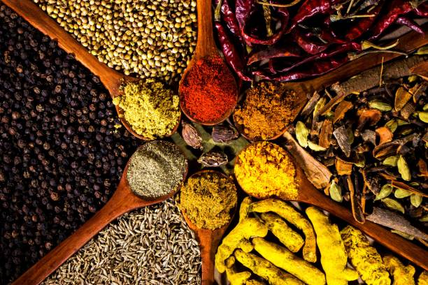 istock Closeup of different spices on wooden spoons 1446409948