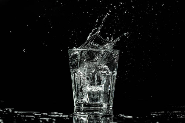 acqua in vetro isolata su fondo nero. spruzzi e gocce d'acqua. banner, menu catering ricetta posto per il testo, - martini brand vermouth foto e immagini stock