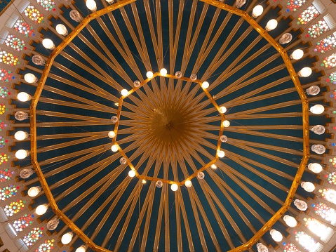 Interior shot of ceiling of famous King Abdullah I Mosque at low angle with original architectural highlights, Amman, Jordan.