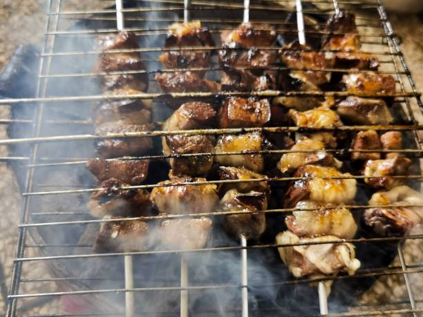 istock Meat skewers in a metal grid on a coal fire 1446415228