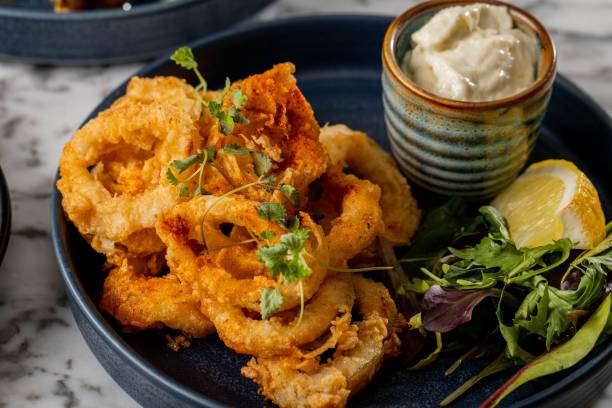 closeup of fried onion rings on a table - lökring bildbanksfoton och bilder