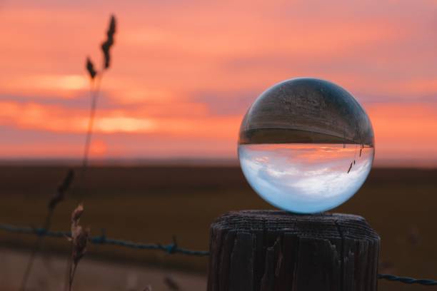istock Clear glass ball on a wooden post in a ranch during sunset 1446417420