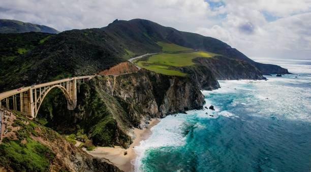 istock Aerial view of sea breaking beach with greenery mountains 1446418689